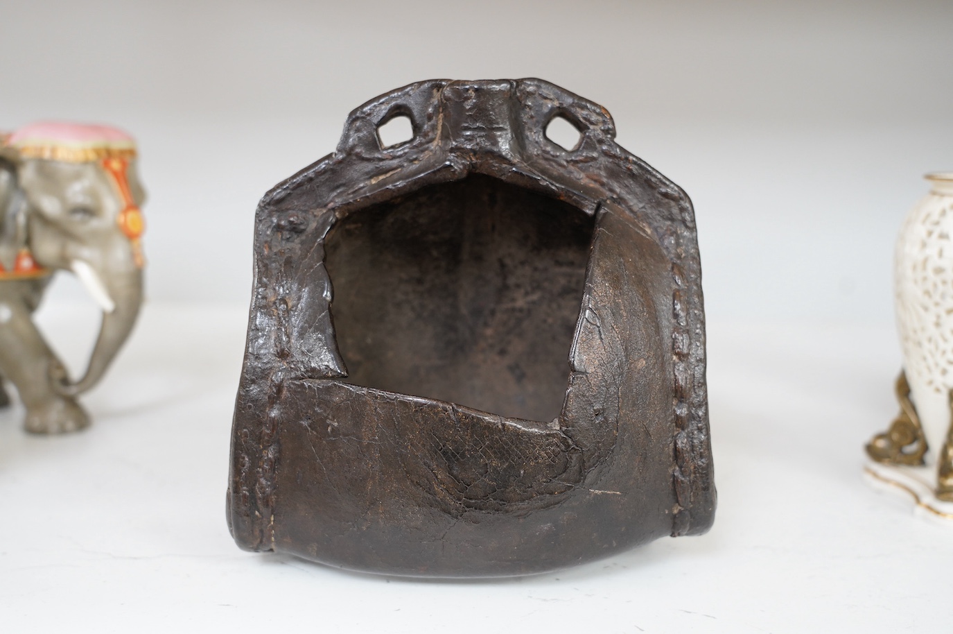 An 18th century leather cider costrel, 18cm tall. Condition - large hole cut out of one side